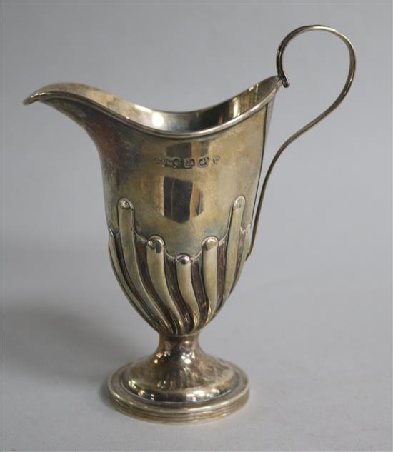 A Victorian demi-fluted silver helmet shaped cream jug by George Unite , Birmingham, 1896,	 12cm.